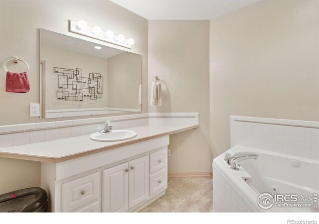 2143 Meadow Ct, Longmont, CO 80501 - full bath featuring a tub with jets, vanity, and baseboards