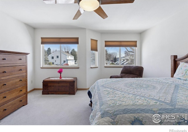 2143 Meadow Ct, Longmont, CO 80501 - bedroom featuring multiple windows, carpet floors, baseboards, and ceiling fan