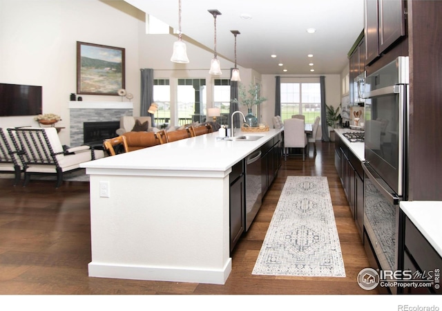 7086 Thunderview Dr, Timnath, CO 80547 - kitchen with a sink, a kitchen island with sink, appliances with stainless steel finishes, light countertops, and recessed lighting
