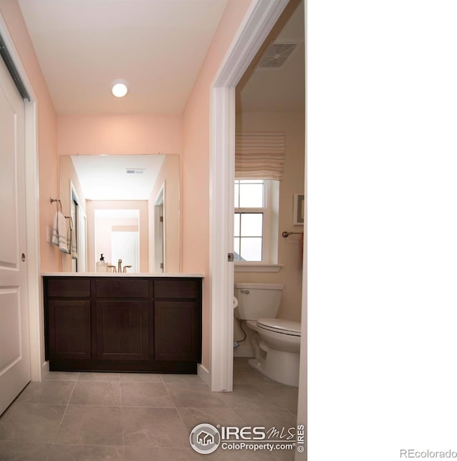 7086 Thunderview Dr, Timnath, CO 80547 - bathroom featuring toilet, tile patterned flooring, vanity, and baseboards