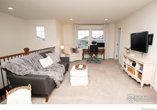 7086 Thunderview Dr, Timnath, CO 80547 - carpeted living room with plenty of natural light, an office area, recessed lighting, and baseboards