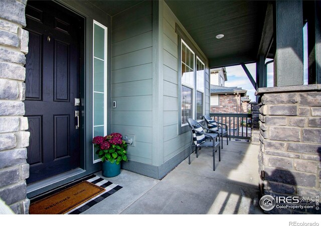7086 Thunderview Dr, Timnath, CO 80547 - view of exterior entry with a porch