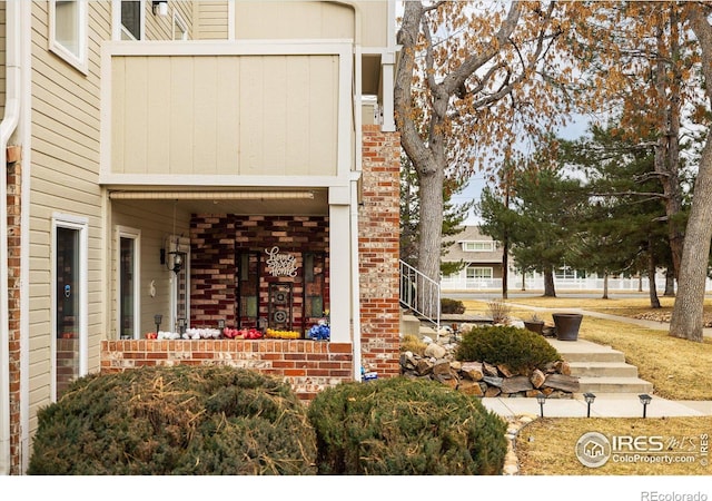 entrance to property featuring brick siding