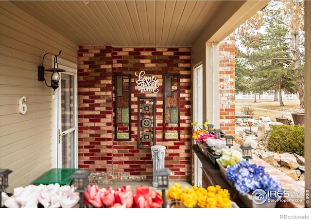 property entrance featuring brick siding