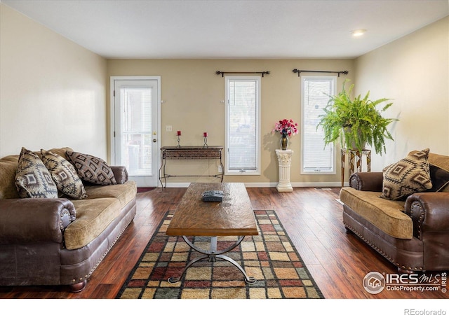 living room with dark wood finished floors and baseboards