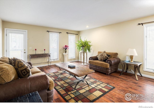 living room featuring dark wood finished floors and baseboards