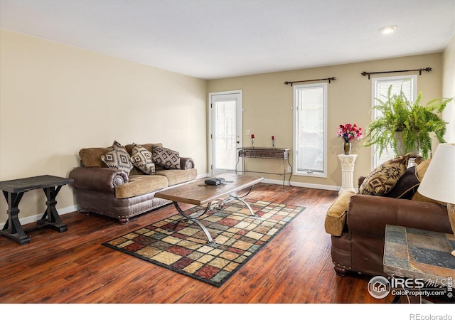 living room with dark wood-style flooring and baseboards