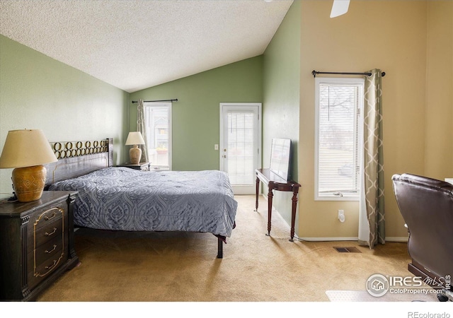 bedroom with lofted ceiling, visible vents, light carpet, a textured ceiling, and baseboards