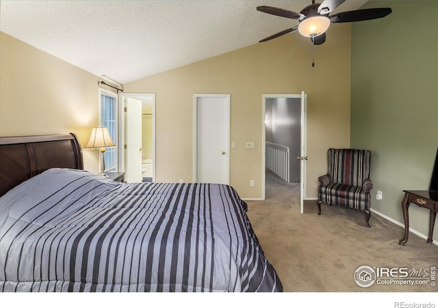 bedroom featuring lofted ceiling, a textured ceiling, baseboards, and light colored carpet