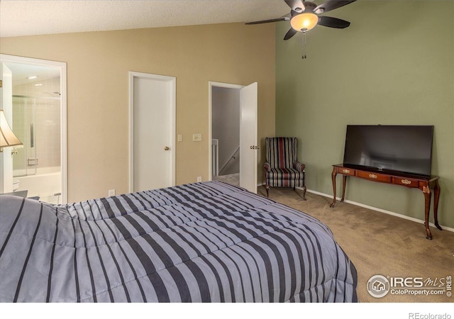 bedroom with lofted ceiling, ensuite bath, carpet flooring, and baseboards