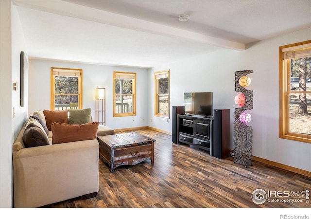 living area featuring dark wood-style flooring, beamed ceiling, and baseboards