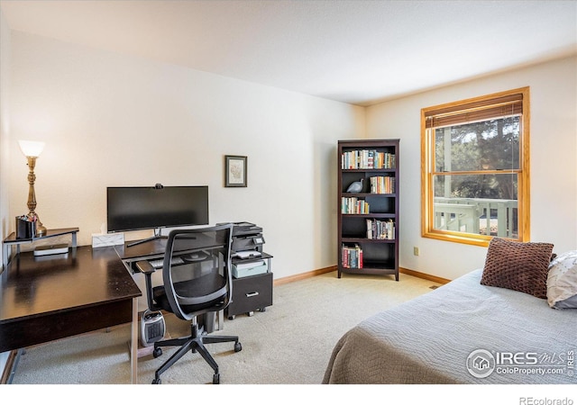 bedroom with baseboards and light colored carpet