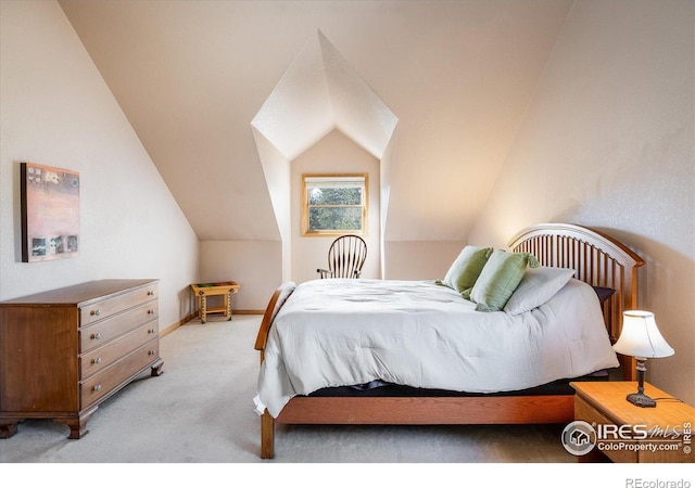 bedroom with light carpet, baseboards, and lofted ceiling