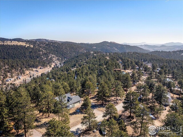 aerial view with a wooded view and a mountain view