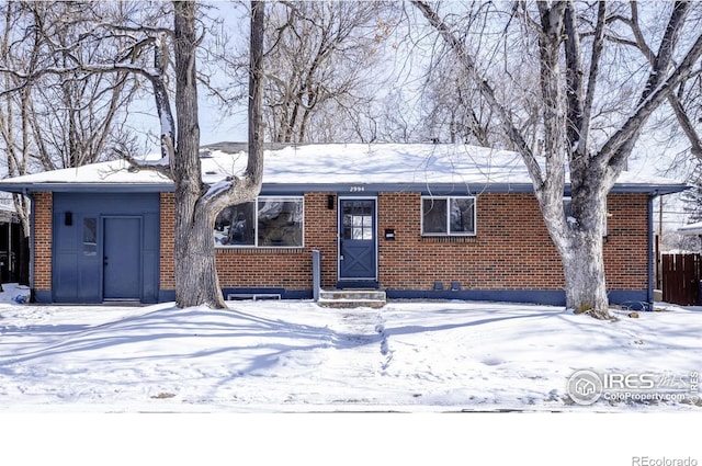 single story home featuring entry steps, crawl space, and brick siding