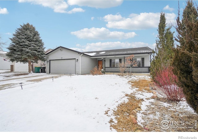 ranch-style home featuring covered porch and an attached garage