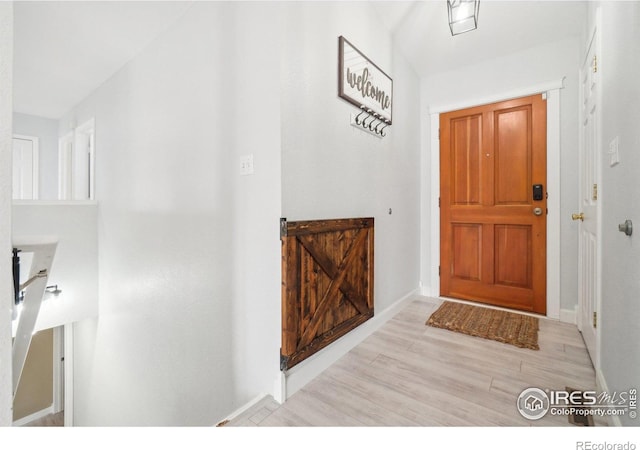 entryway featuring light wood-style floors and baseboards