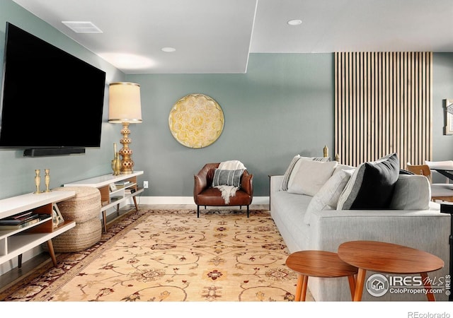 living area with baseboards, recessed lighting, and visible vents