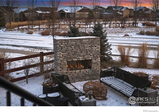 exterior space featuring an outdoor stone fireplace and a residential view