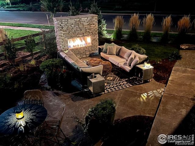 view of patio featuring an outdoor living space with a fireplace