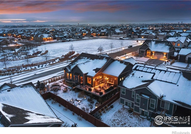 snowy aerial view with a residential view