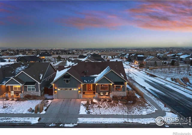 snowy aerial view featuring a residential view
