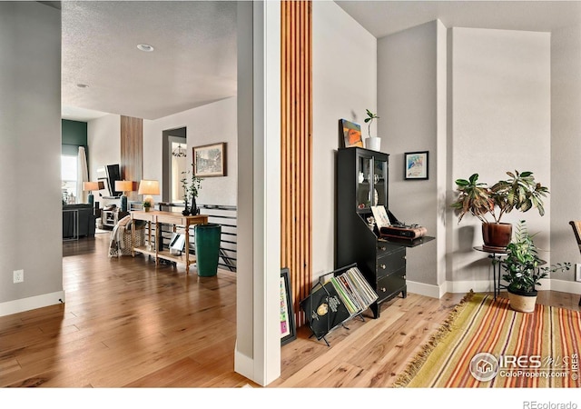 hallway with baseboards and wood finished floors