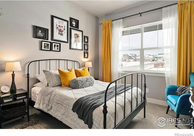 carpeted bedroom featuring baseboards