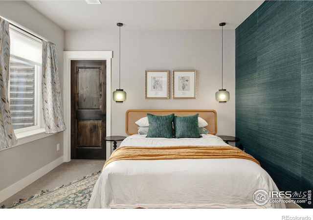 carpeted bedroom featuring baseboards