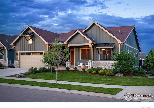 2025 Orchard Bloom Dr, Windsor, CO 80550 - craftsman-style house with covered porch, a front lawn, board and batten siding, and driveway