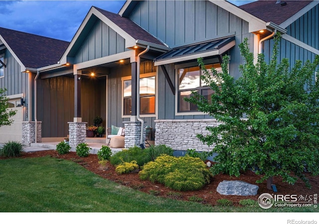 2025 Orchard Bloom Dr, Windsor, CO 80550 - view of front of home featuring stone siding, board and batten siding, roof with shingles, and a front yard