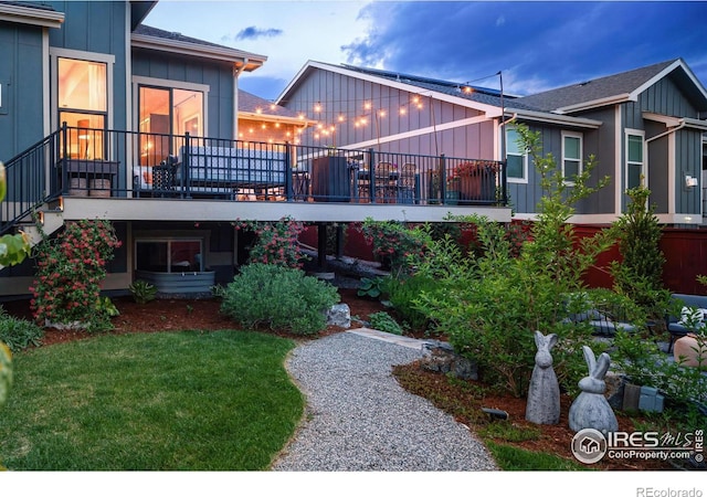 2025 Orchard Bloom Dr, Windsor, CO 80550 - rear view of property with board and batten siding, a yard, and roof with shingles