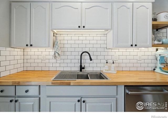 kitchen with white cabinetry, open shelves, and a sink