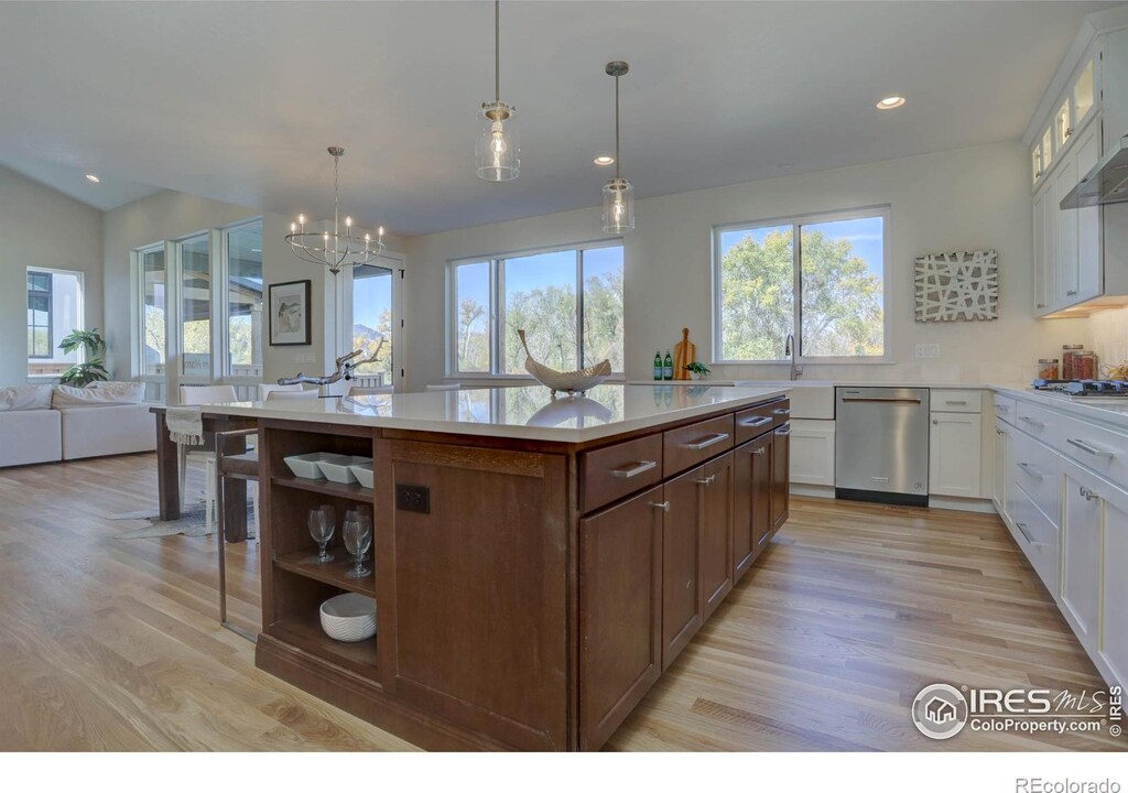 913 Saint Andrews Ln, Louisville, CO 80027 - kitchen with light countertops, stainless steel dishwasher, decorative light fixtures, and white cabinets