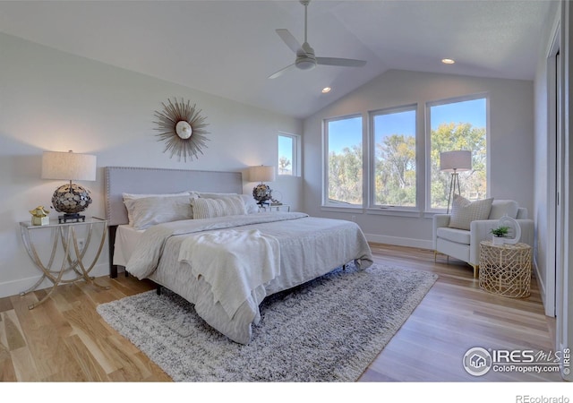 bedroom with lofted ceiling, light wood-style flooring, baseboards, and ceiling fan