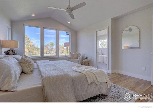 bedroom featuring connected bathroom, a ceiling fan, baseboards, vaulted ceiling, and light wood-type flooring