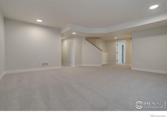 unfurnished room with baseboards, stairs, visible vents, and recessed lighting