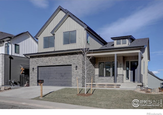 modern farmhouse with covered porch, concrete driveway, board and batten siding, a garage, and stone siding