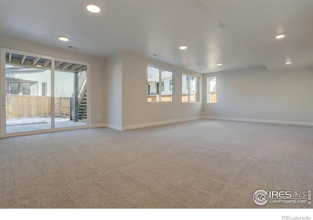 unfurnished room with recessed lighting, light carpet, baseboards, and stairs