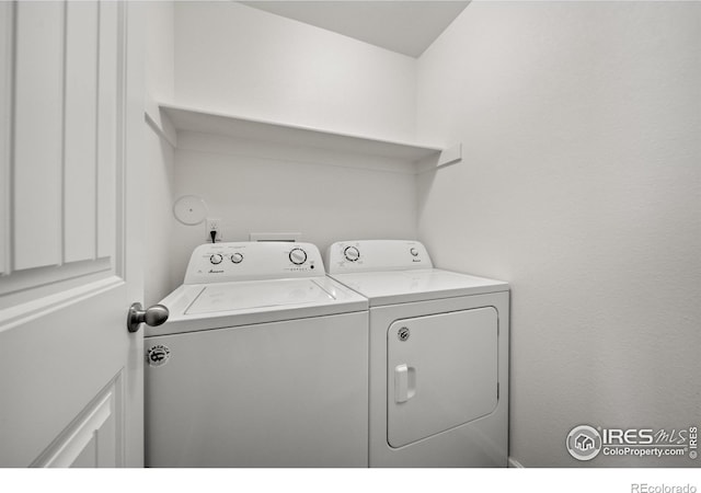 clothes washing area featuring laundry area and washer and dryer