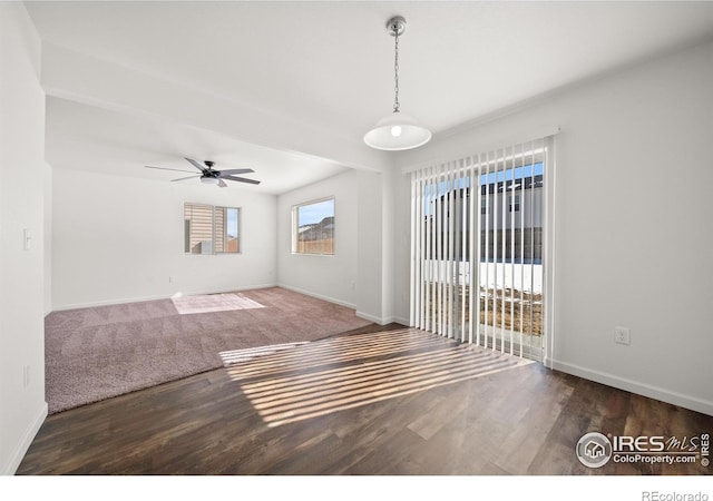 unfurnished room featuring a ceiling fan, baseboards, and wood finished floors