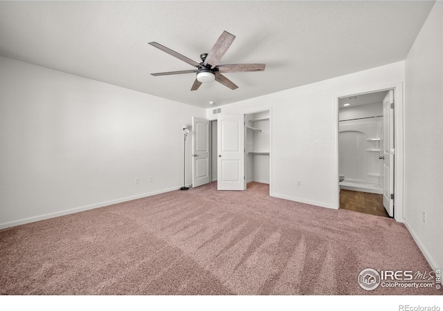 unfurnished bedroom with ensuite bathroom, carpet floors, a closet, and baseboards