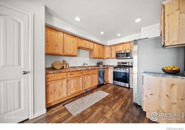 kitchen featuring dark wood-style floors, light brown cabinetry, appliances with stainless steel finishes, and recessed lighting