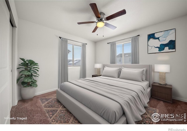 bedroom featuring carpet floors, multiple windows, and baseboards