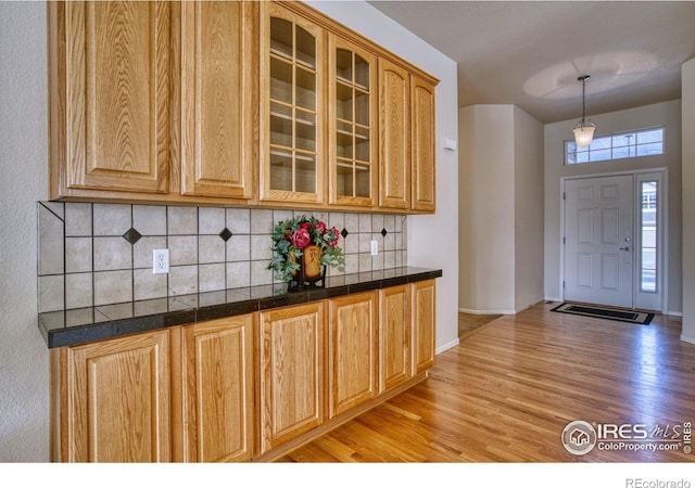 foyer entrance featuring light wood-style floors and baseboards