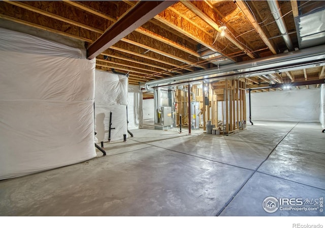 unfinished basement featuring gas water heater