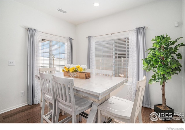 dining area with dark wood-style floors, baseboards, visible vents, and recessed lighting