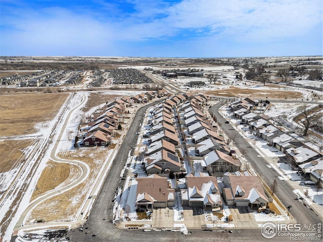 snowy aerial view featuring a residential view