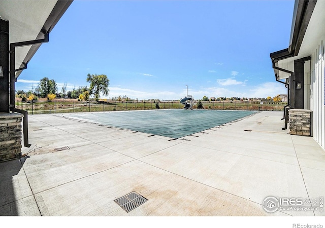 pool featuring a patio area and a fenced backyard