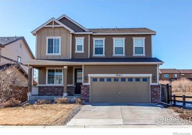 craftsman house with board and batten siding, brick siding, driveway, and fence